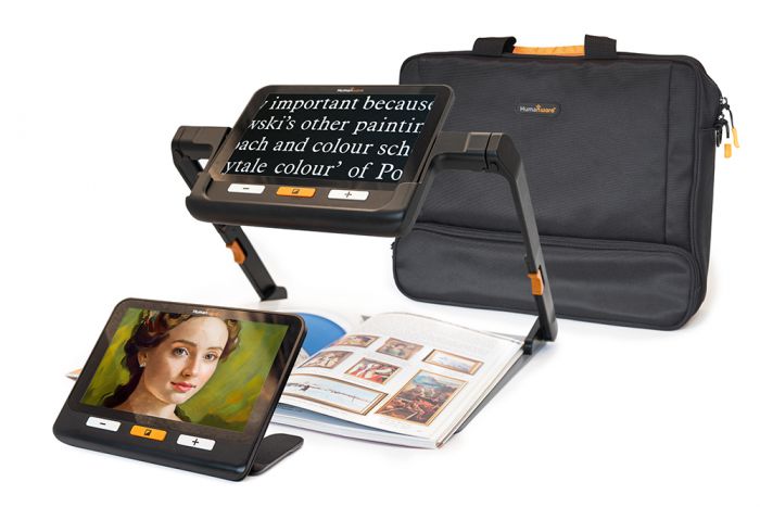 The explore 8 device shown on the table top, as well as in its stand along with the travel bag behind them both.