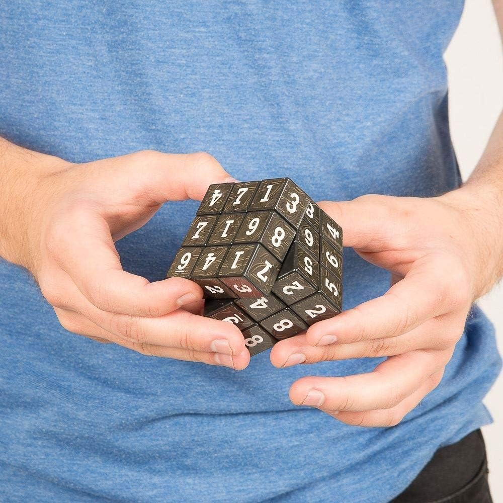 hands holding the sudoku cube puzzle game.